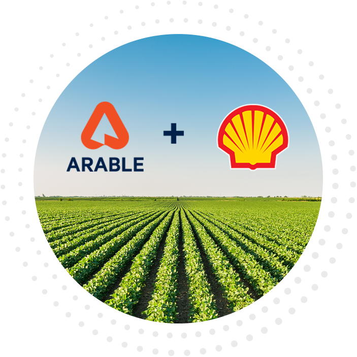 Arable logo plus Shell logo in the blue sky over rows of crops